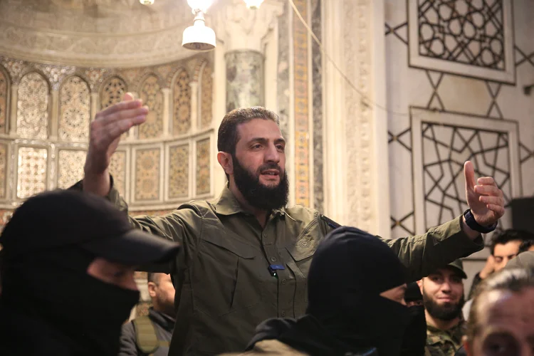 The leader of Syria's Islamist Hayat Tahrir al-Sham (HTS) group that headed a lightning rebel offensive snatching Damascus from government control, Abu Mohammed al-Jolani, address a crowd at the capital's landmark Umayyad Mosque on December 8, 2024. Jolani, now using his real name Ahmed al-Sharaa, gave a speech as the crowd chanted "Allahu akbar (God is greatest)," a video shared by the rebels on their Telegram channel showed. (Photo by Aref TAMMAWI / AFP) (AFP Photo)