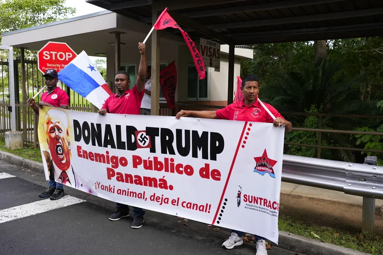 Demonstrators hold a banner that reads "Donald Trump, public enemy of Panama," during a protest outside the US embassy in Panama City on December 24, 2024. The status of the Panama Canal is non-negotiable, President Jose Raul Mulino said in a statement on December 23 signed alongside former leaders of the country after Donald Trump's recent threats to reclaim the man-made waterway. (Photo by ARNULFO FRANCO / AFP) (AFP Photo/AFP Photo)