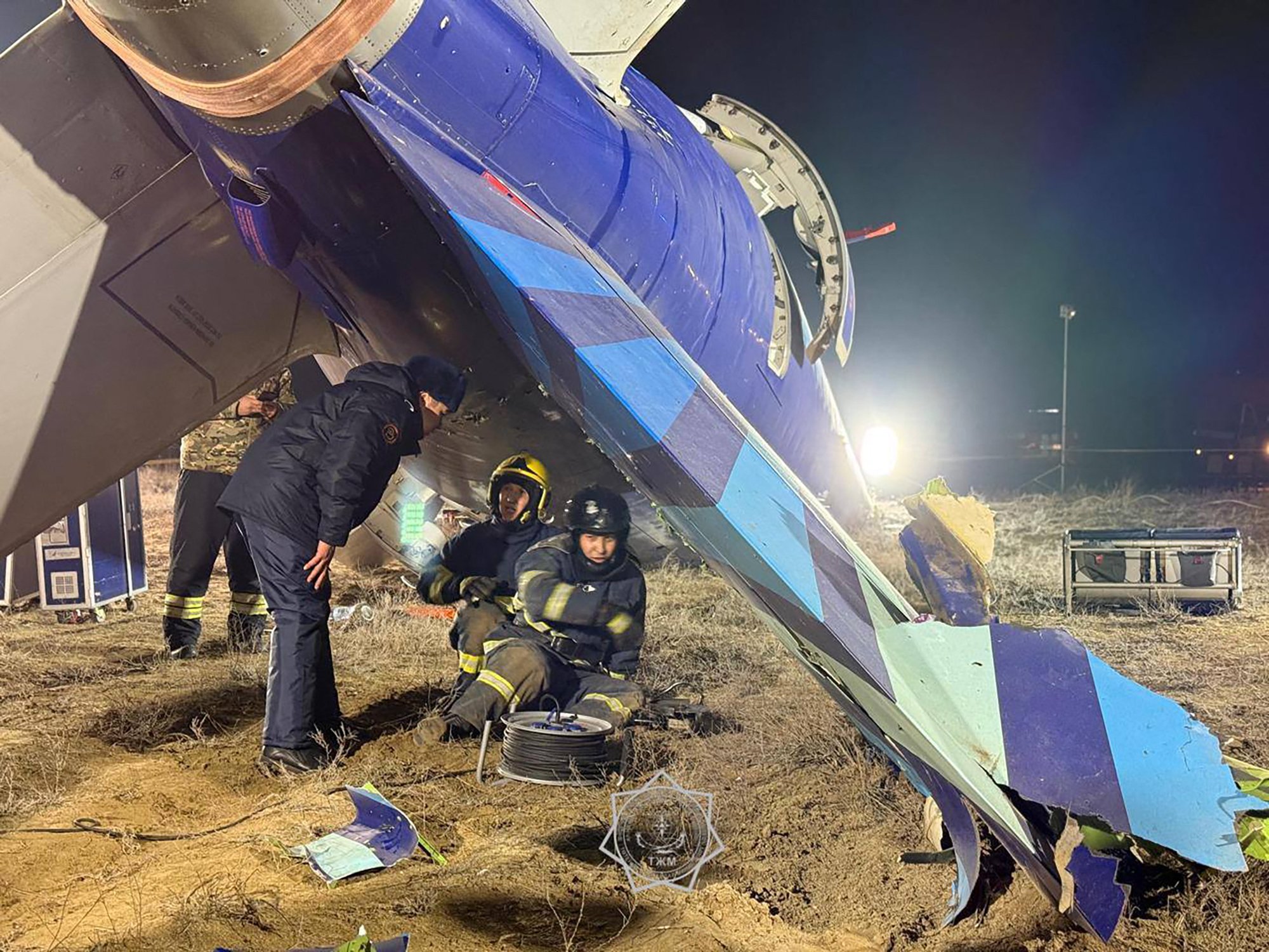 In this handout picture released by Kazakhstan's emergency situations ministry on December 26, 2024, emergency specialists work at the crash site of an Azerbaijan Airlines passenger jet near the western Kazakh city of Aktau. (Photo by Handout / Kazakhstan's emergency situations ministry / AFP) / RESTRICTED TO EDITORIAL USE - MANDATORY CREDIT "AFP PHOTO / Kazakhstan's emergency situations ministry / handout" - NO MARKETING NO ADVERTISING CAMPAIGNS - DISTRIBUTED AS A SERVICE TO CLIENTS