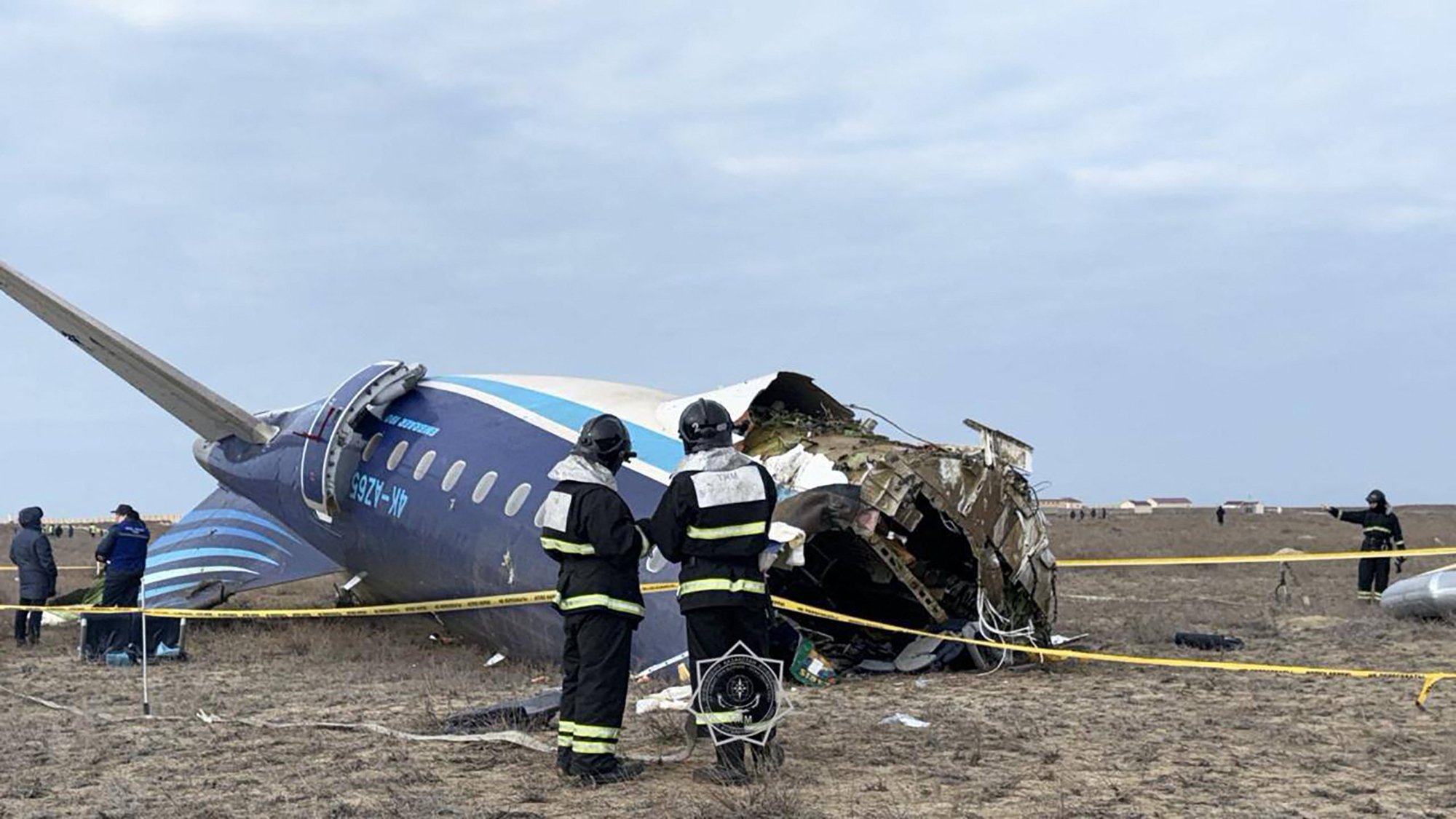 In this handout picture released by Kazakhstan's emergency situations ministry, emergency specialists work at the crash site of an Azerbaijan Airlines passenger jet near the western Kazakh city of Aktau on December 25, 2024. (Photo by Handout / Kazakhstan's emergency situations ministry / AFP) / RESTRICTED TO EDITORIAL USE - MANDATORY CREDIT "AFP PHOTO / Kazakhstan's emergency situations ministry / handout" - NO MARKETING NO ADVERTISING CAMPAIGNS - DISTRIBUTED AS A SERVICE TO CLIENTS