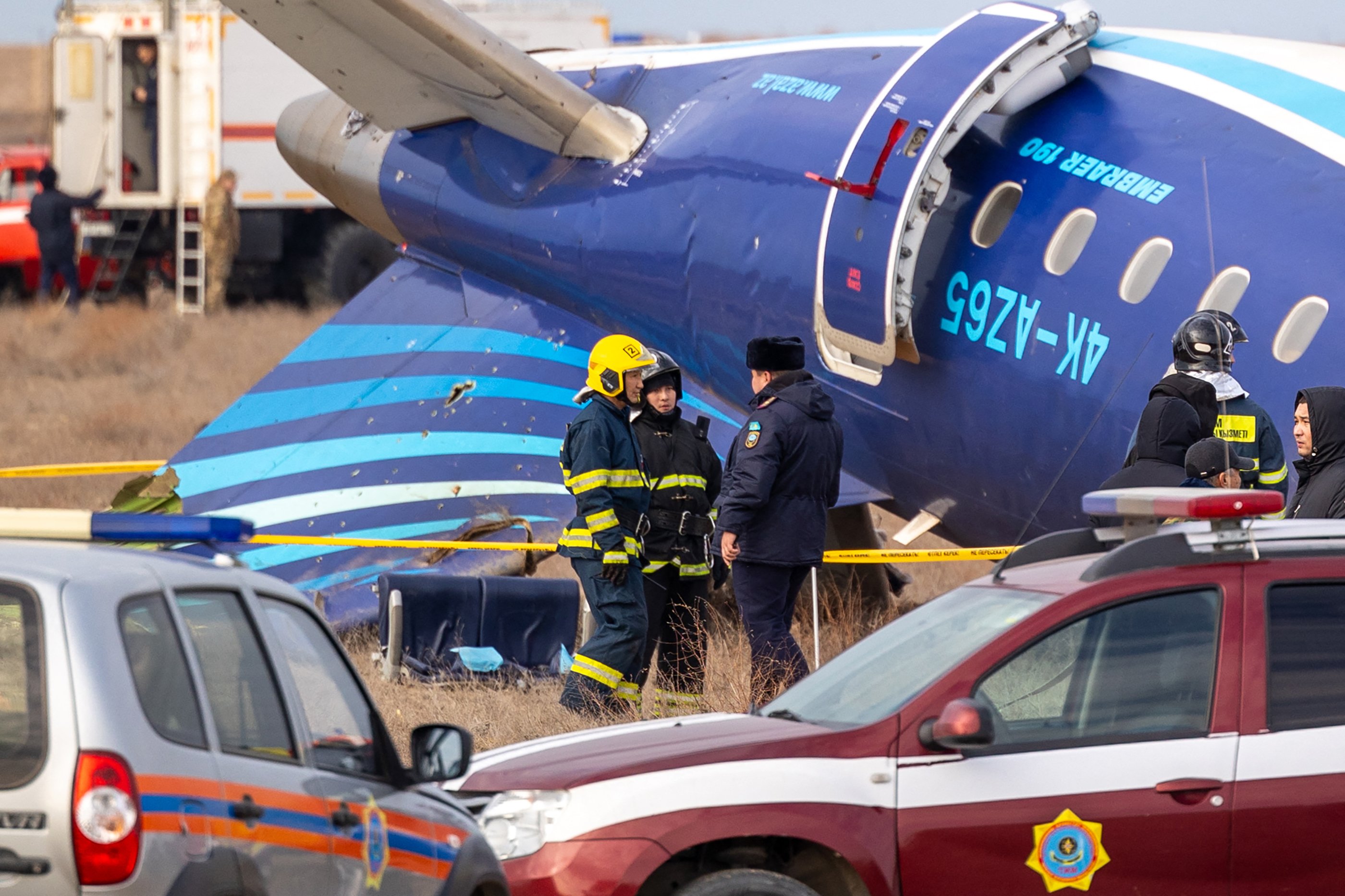 Emergency specialists work at the crash site of an Azerbaijan Airlines passenger jet near the western Kazakh city of Aktau on December 25, 2024. The Embraer 190 aircraft was supposed to fly northwest from the Azerbaijani capital Baku to the city of Grozny in Chechnya in southern Russia, but instead diverted far off course across the Caspian Sea. It crashed on December 25, 2024 near the city of Aktau in Kazakhstan. (Photo by Issa Tazhenbayev / AFP)