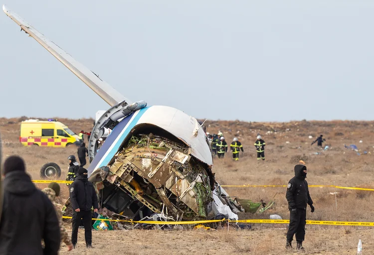 Emergency specialists work at the crash site of an Azerbaijan Airlines passenger jet near the western Kazakh city of Aktau on December 25, 2024. (Photo by Issa Tazhenbayev / AFP) (Handout/ Kazakhstan's emergency situations ministry/AFP)