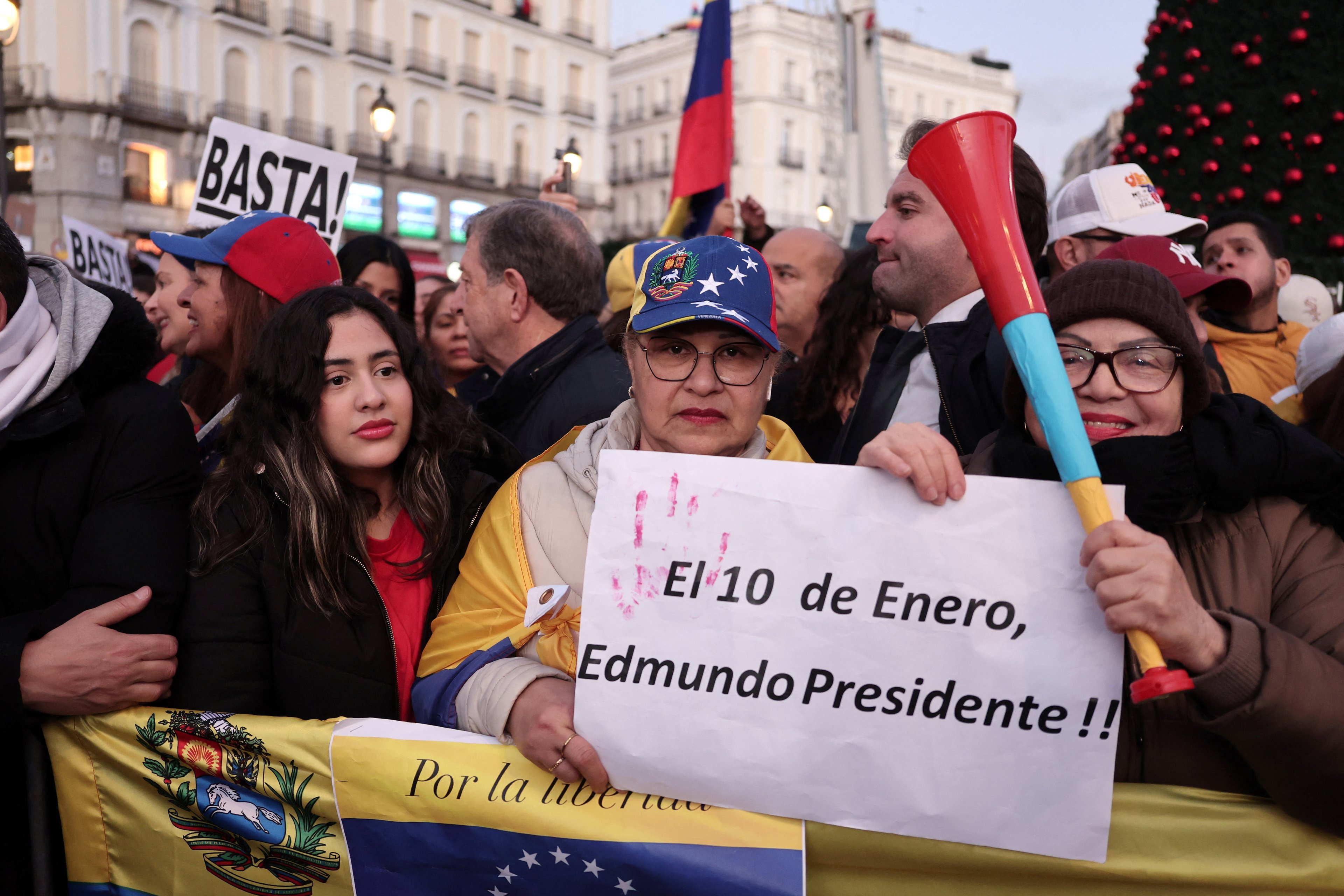 A protester holds a sign reading 'On January 10, (Venezuela's opposition candidate) Edmundo Gonzalez, President', in Madrid on January 9, 2025 during a demonstration for democracy in Venezuela, and in support of Venezuela's opposition candidate Edmundo Gonzalez, on the eve of the Venezuela's presidential inauguration. (Photo by Thomas COEX / AFP)