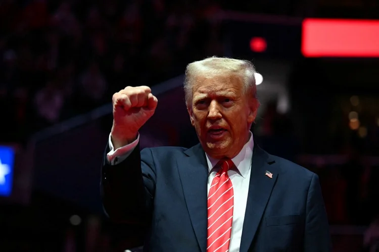 US President-elect Donald Trump reacts during a MAGA victory rally at Capital One Arena in Washington, DC, on January 19, 2025, one day ahead of his inauguration ceremony. (Photo by Jim WATSON / AFP)