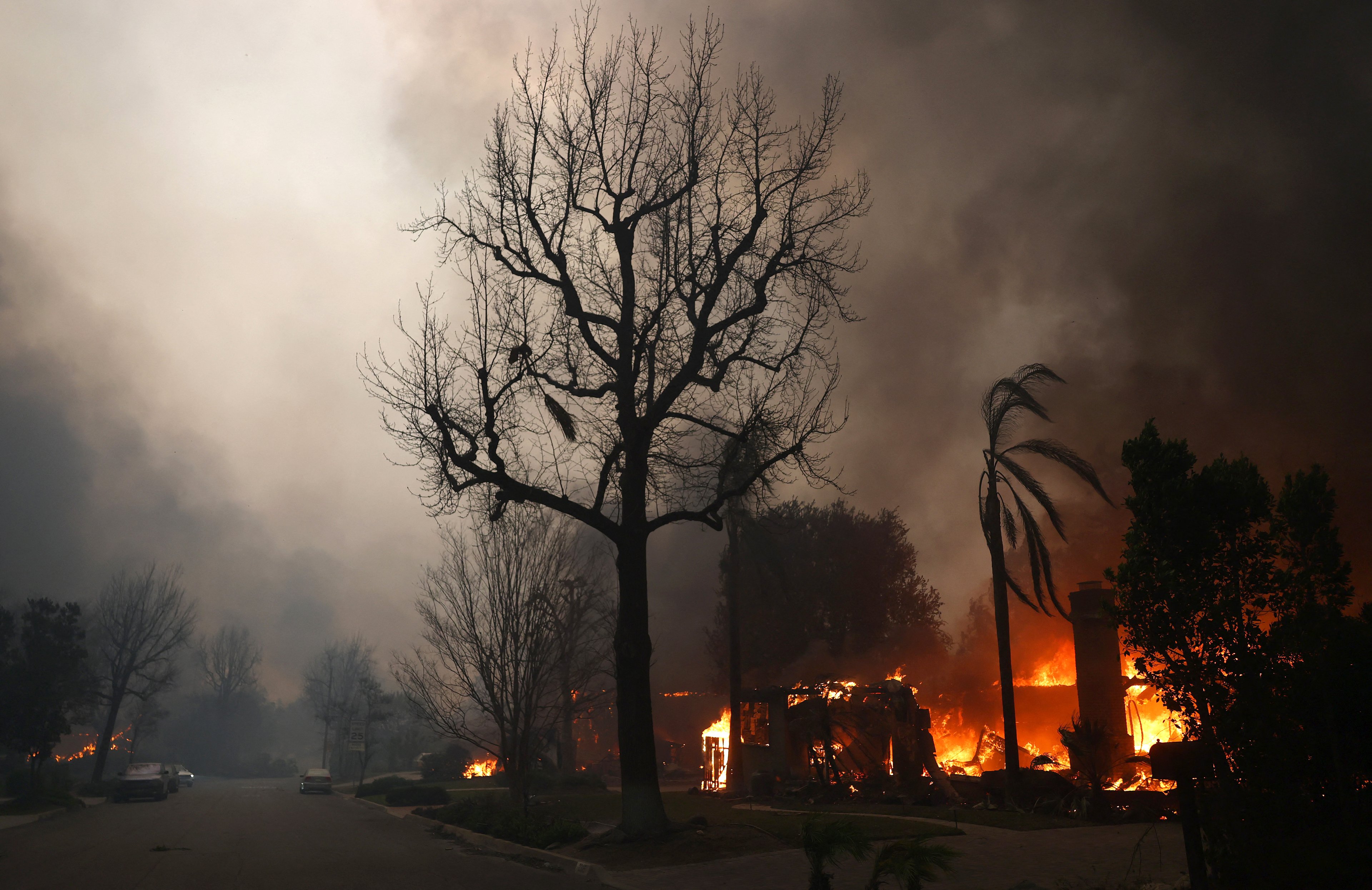 ALTADENA, CALIFORNIA - JANUARY 08: Homes burn during the Eaton Fire on January 8, 2025 in Altadena, California. Over 1,000 structures have burned, with two people dead, in wildfires fueled by intense Santa Ana Winds across L.A. County.   Mario Tama/Getty Images/AFP (Photo by MARIO TAMA / GETTY IMAGES NORTH AMERICA / Getty Images via AFP)