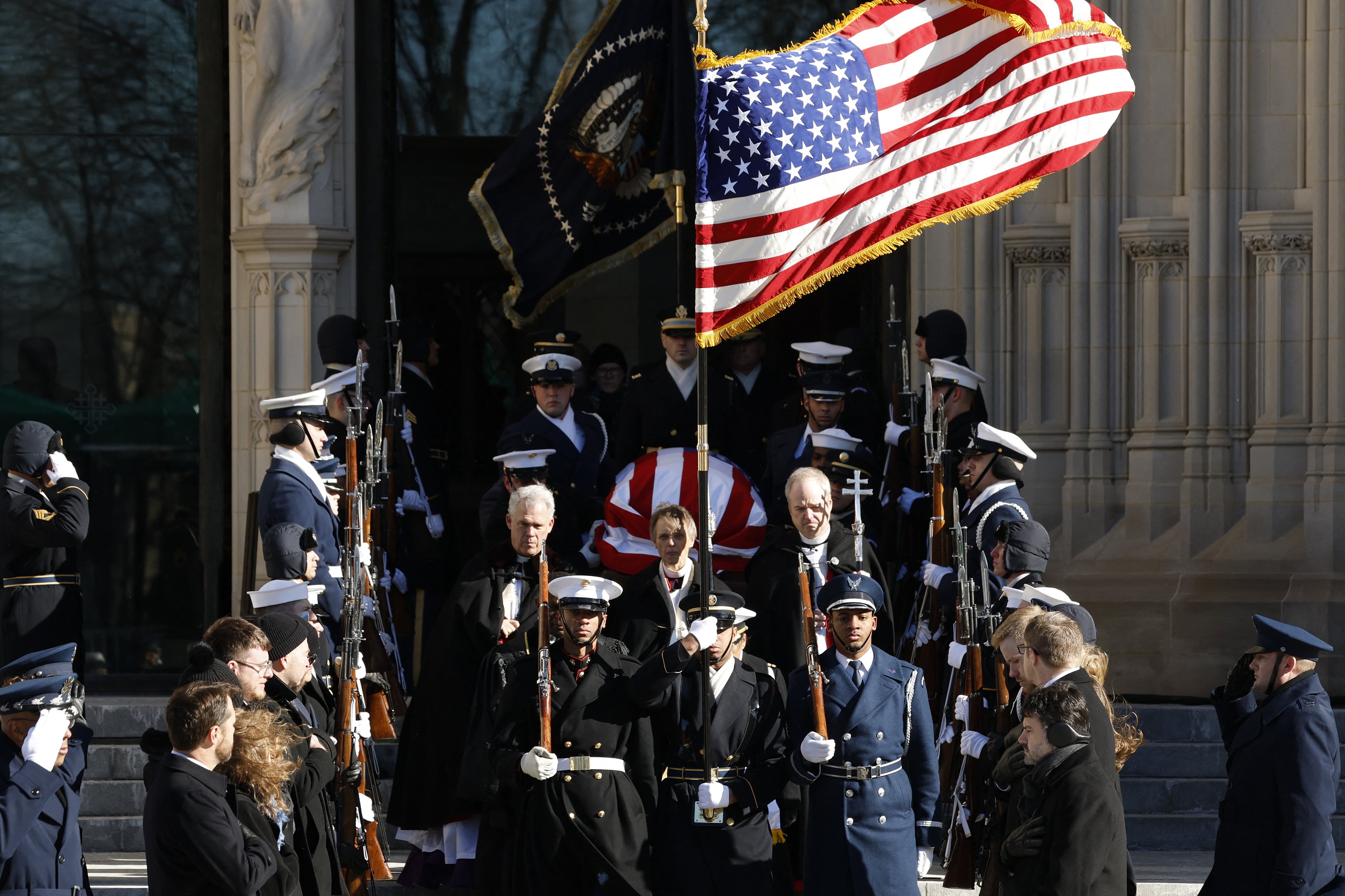 WASHINGTON, DC - JANUARY 09: U.S. Military Body Bearers carry the flag-draped casket bearing the remains of former U.S. President Jimmy Carter from the Washington National Cathedral following his state funeral on January 09, 2025 in Washington, DC. President Joe Biden declared today a national day of mourning for Carter, the 39th President of the United States, who died at the age of 100 on December 29, 2024 at his home in Plains, Georgia. Following the state funeral, Carters remains will be returned to Plains, Georgia where he will be interred after a private family service.   Anna Moneymaker/Getty Images/AFP (Photo by Anna Moneymaker / GETTY IMAGES NORTH AMERICA / Getty Images via AFP)