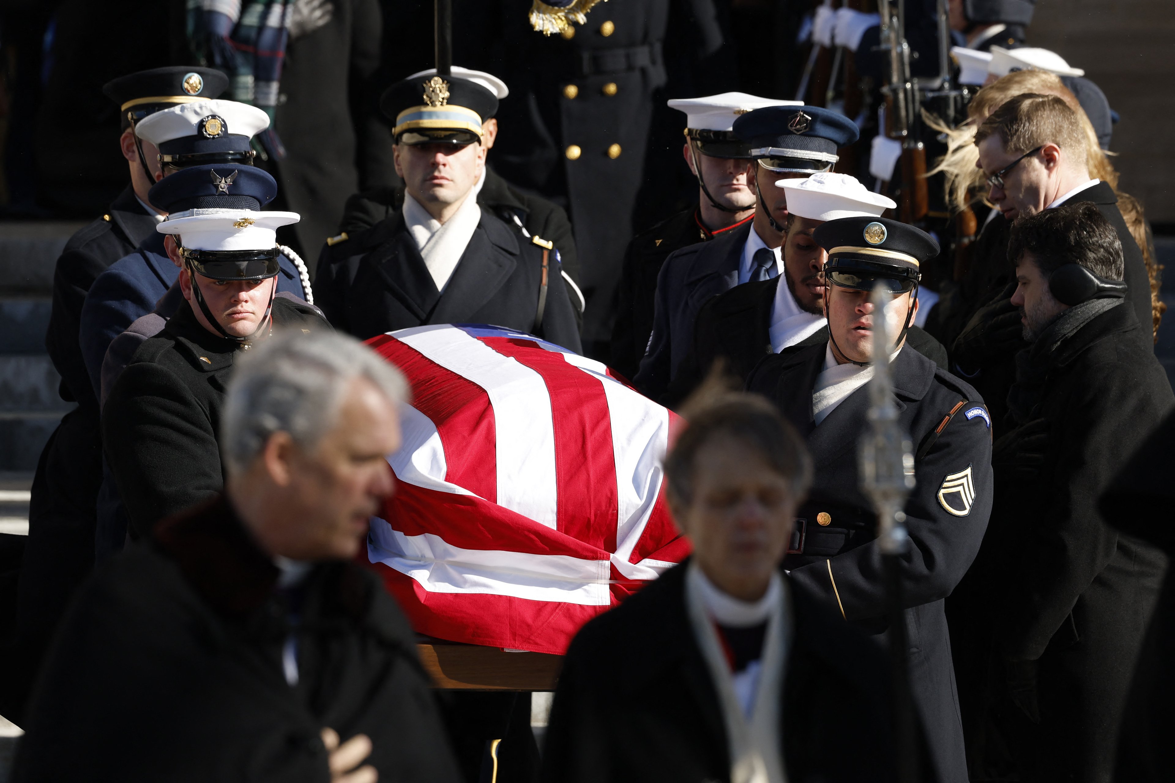 WASHINGTON, DC - JANUARY 09: U.S. Military Body Bearers carry the flag-draped casket bearing the remains of former U.S. President Jimmy Carter from the Washington National Cathedral following his state funeral on January 09, 2025 in Washington, DC. President Joe Biden declared today a national day of mourning for Carter, the 39th President of the United States, who died at the age of 100 on December 29, 2024 at his home in Plains, Georgia. Following the state funeral, Carters remains will be returned to Plains, Georgia where he will be interred after a private family service.   Anna Moneymaker/Getty Images/AFP (Photo by Anna Moneymaker / GETTY IMAGES NORTH AMERICA / Getty Images via AFP)