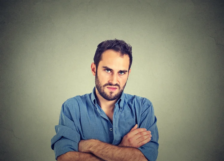 Closeup portrait of angry young man, about to have nervous breakdown, isolated on gray wall background. Negative human emotions facial expression feelings attitude (	SIphotography/Getty Images)