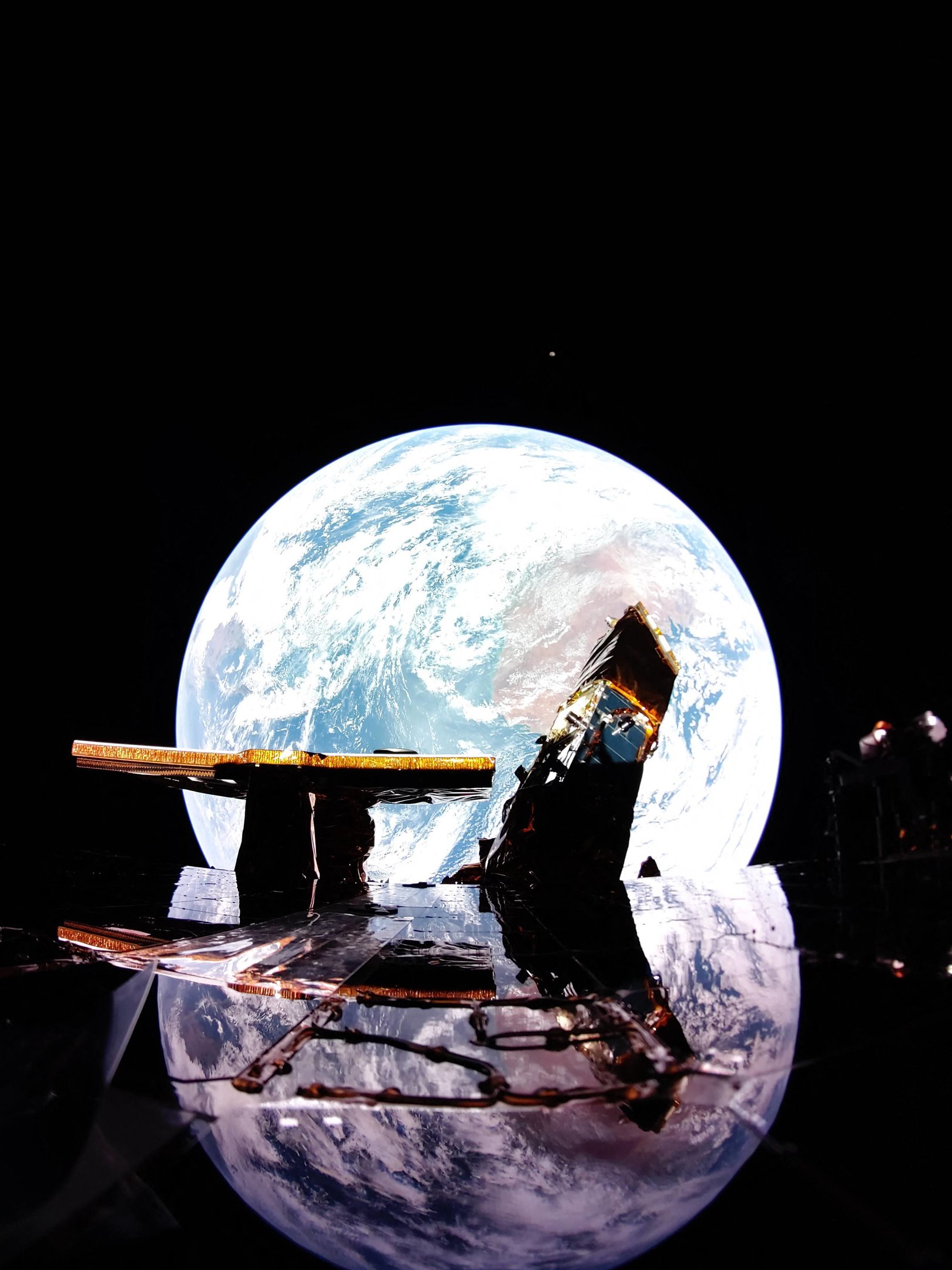 This undated image released by Firefly Aerospace Blue Ghost captures Earth reflecting off the solar panel with the Moon on the horizon. More than fifty years passed between the last Apollo mission and America's return to the lunar surface, when the first ever private lander touched down last February. Now, starting March 2, two more missions are set to follow within a single week -- marking a bold push by NASA and its industry partners to make Moon landings a routine part of space exploration. (Photo by Handout / Firefly Aerospace / AFP) / RESTRICTED TO EDITORIAL USE - MANDATORY CREDIT "AFP PHOTO / Firefly Aerospace" - NO MARKETING NO ADVERTISING CAMPAIGNS - DISTRIBUTED AS A SERVICE TO CLIENTS