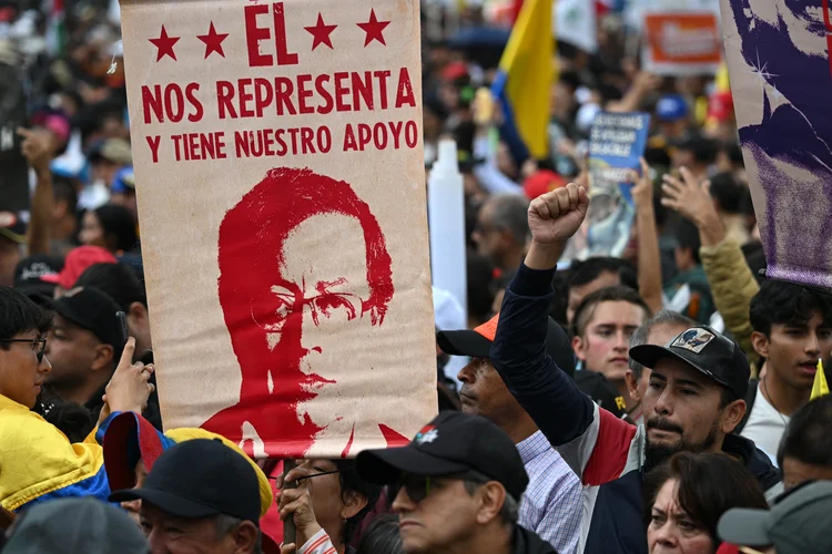 A supporter of Colombia's President Gustavo Petro holds up a sign that reads "He represents us and has our support" during a rally in Bogota on March 18, 2025, to pressure Congress to approve the government reforms. Colombia's President Gustavo Petro has called for a referendum on a signature labor bill after it was torpedoed by senators in the latest setback to his left-wing reform agenda. Petro issued a call for Colombians "to mobilize" on March 18 across the country against the "sinking" of the legislation. (Photo by RAUL ARBOLEDA / AFP) (AFP)