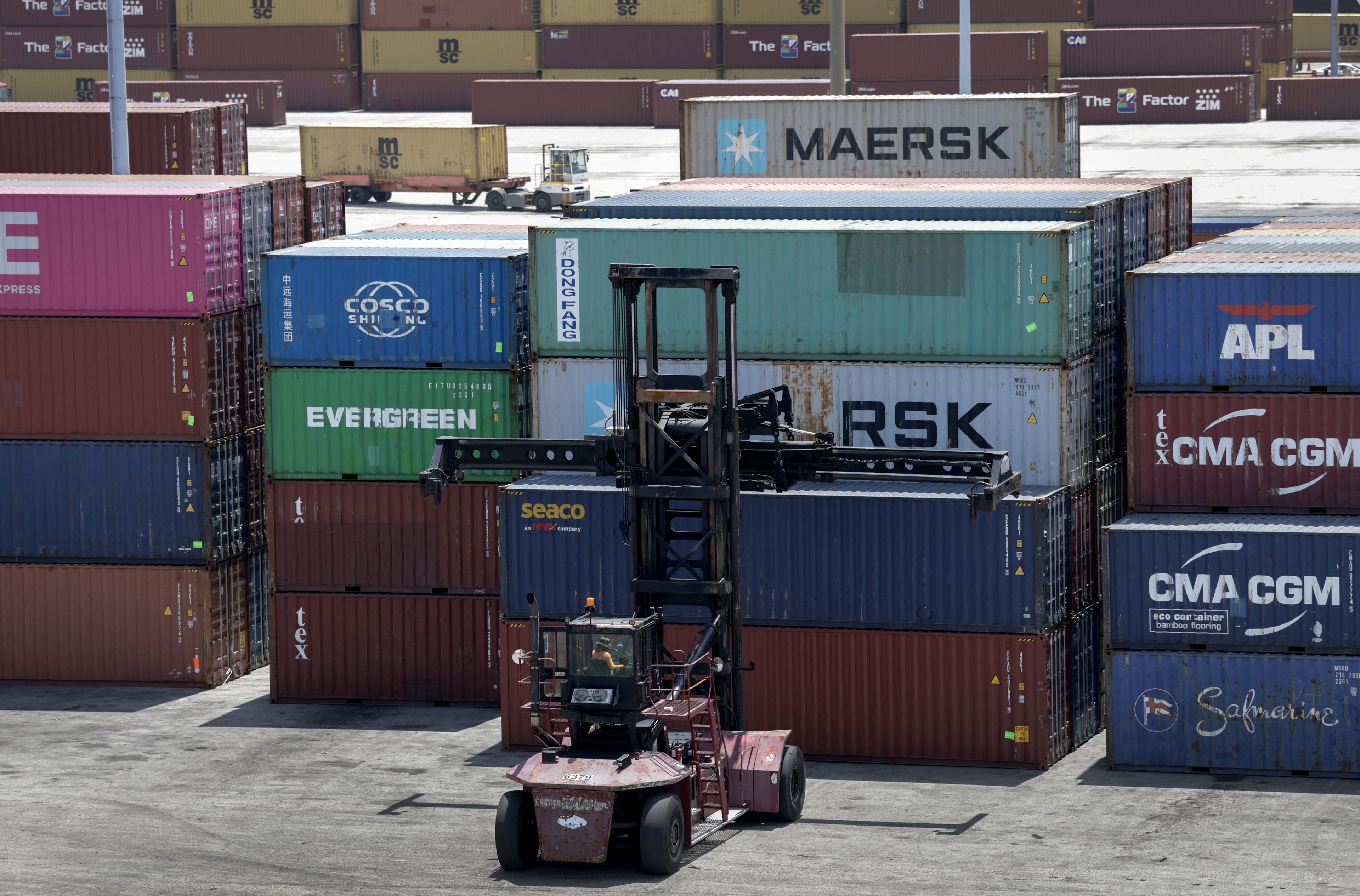MIAMI, FLORIDA - APRIL 07: A forklift moves shipping containers at PortMiami on April 07, 2025 in Miami, Florida. U.S. President Donald Trump continues with his sweeping tariffs on imported goods, causing markets worldwide to react negatively.   Joe Raedle/Getty Images/AFP (Photo by JOE RAEDLE / GETTY IMAGES NORTH AMERICA / Getty Images via AFP)