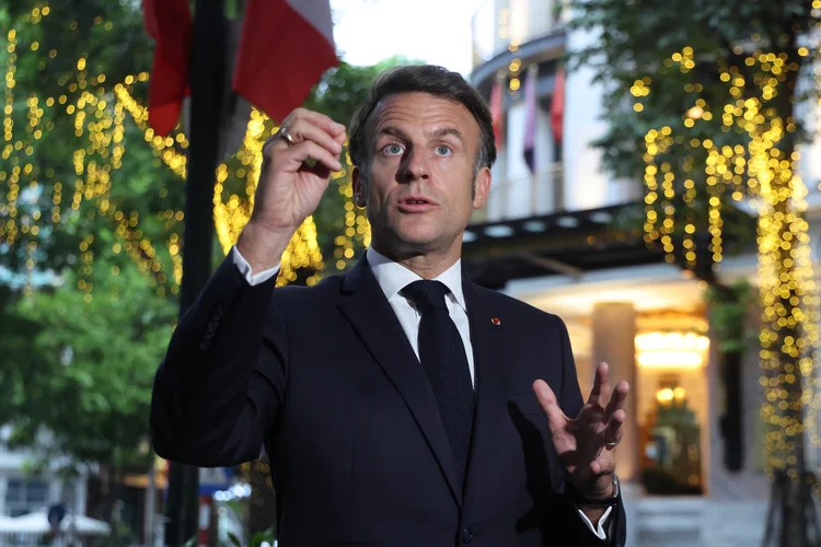 France's President Emmanuel Macron gives a press statement near the Metropole Hotel before attending a state dinner in Hanoi on May 26, 2025. (Photo by Ludovic MARIN / POOL / AFP)