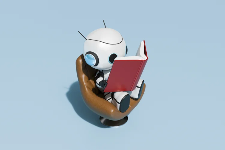 Robô lê livro: queria entender as conversas sobre inteligência artificial que estão rolando por lá, e confesso que tinha medo de ter perdido alguma atualização importante (Getty Images)