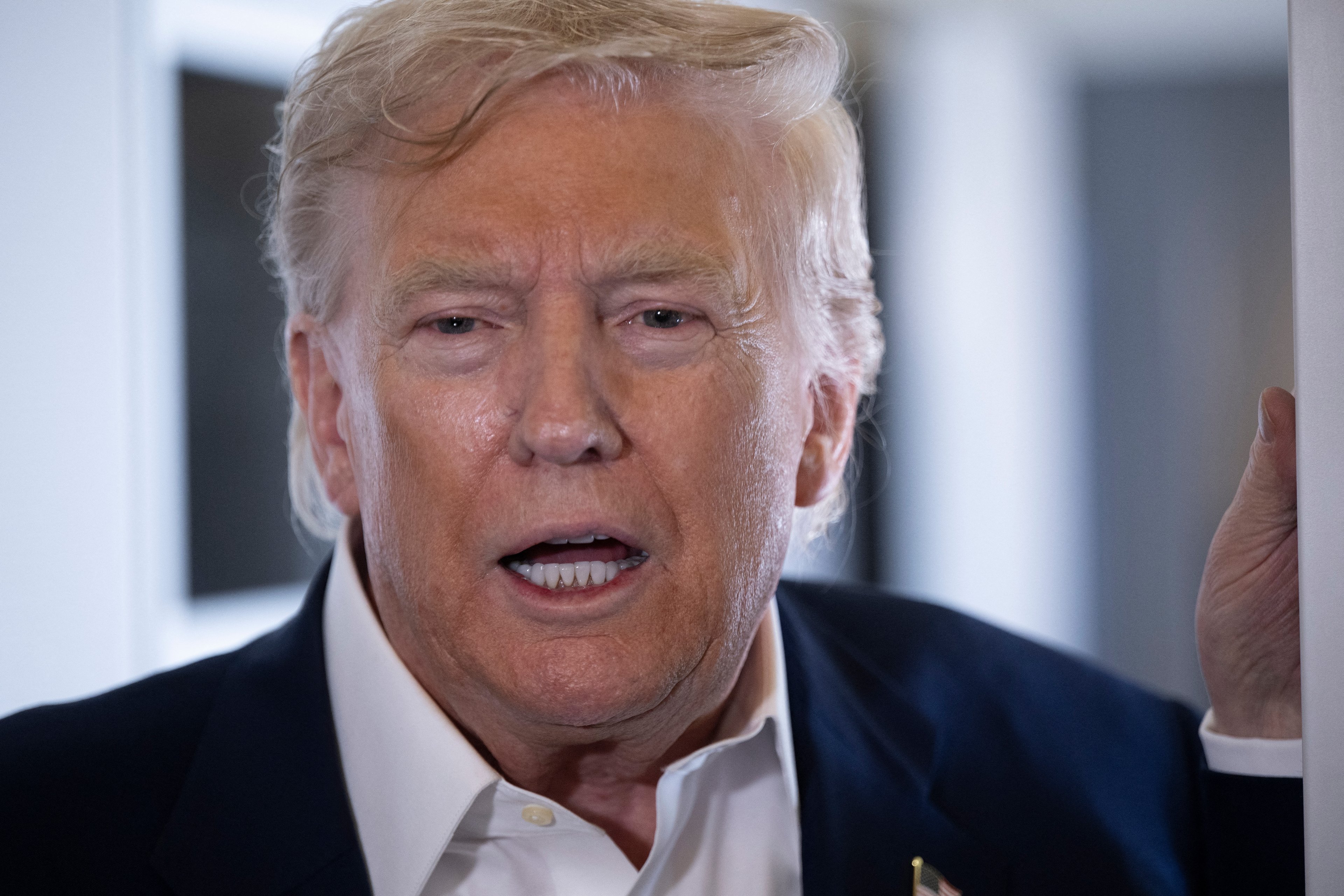 US President Donald Trump speaks to reporters aboard Air Force One over the United Kingdom on July 29, 2025, as he returns to Washington following a trip to Scotland. (Photo by Brendan Smialowski / AFP)