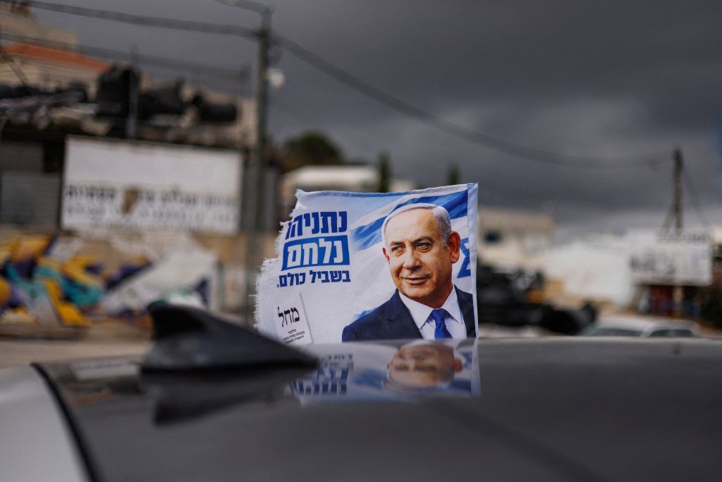 Uma bandeira de campanha eleitoral do primeiro-ministro de Israel e líder do partido Likud, Benjamin Netanyahu, tremula ao vento na vila drusa de Majdal Shams, nas Colinas de Golã — território anexado por Israel —, em 17 de outubro de 2026. Israel vai às urnas no dia 27 de outubro, na primeira eleição desde o ataque liderado pelo Hamas em 7 de outubro de 2023, em um pleito que é visto como um referendo sobre o primeiro-ministro